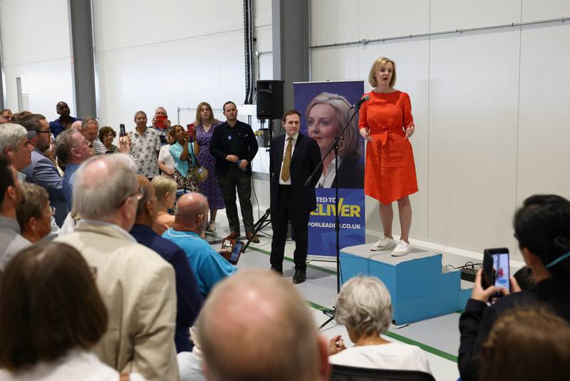 Liz Truss speaks as British Conservative MP Tom Tugendhat looks on at a Conservative Party leadership campaign event at Biggin Hill Airport. Getty Images