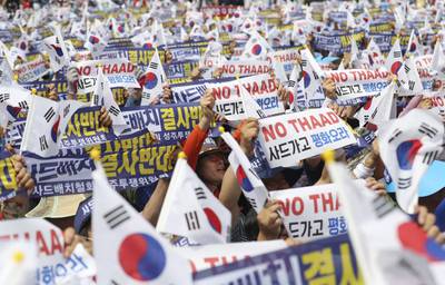 South Koreans protest against a plan to deploy an advanced US missile defence system called Terminal High-Altitude Area Defence, or THAAD, in their neighbourhood outside Seoul. Lee Jin-man / AP Photo