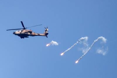 An Israeli Air Force Apache helicopter fires flares in the sky above the Israel-Gaza border. Reuters