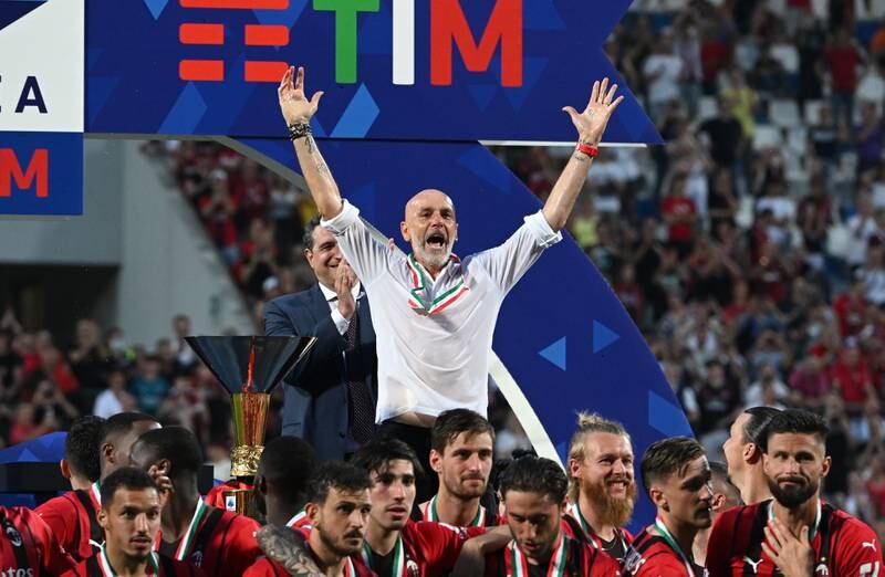 AC Milan manager Stefano Pioli and his players celebrate after winning the Serie A title. Getty