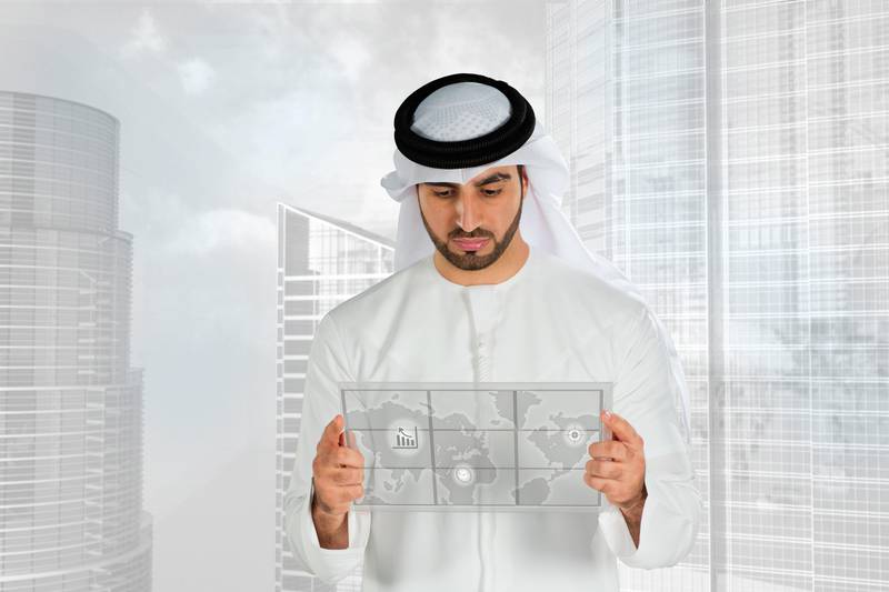 Arab man holding a futuristic monitor screen.