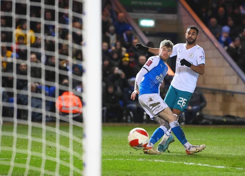 Riyad Mahrez of Manchester City scores his team's first goal during the Emirates FA Cup fifth round match at Peterborough. Getty