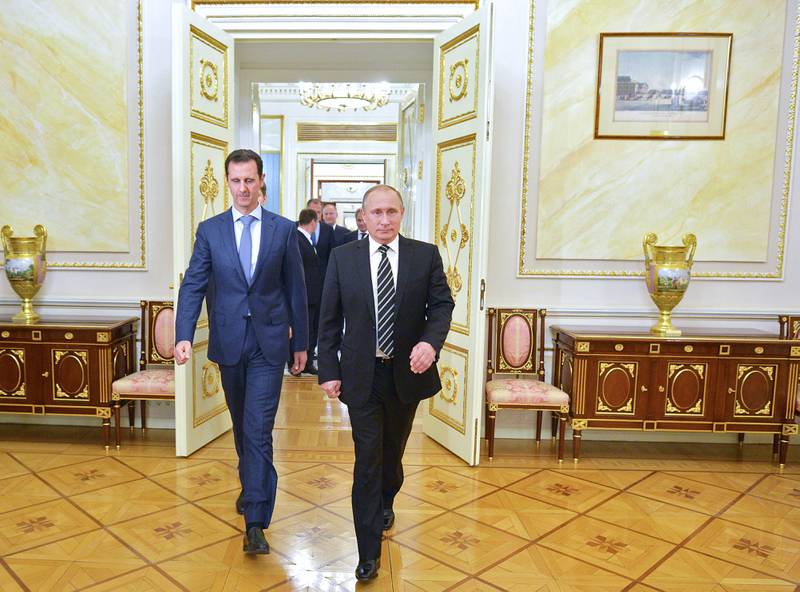 Russian President Vladimir Putin, right, with his Syrian counterpart Bashar Al Assad upon the latter's for a meeting at the Kremlin in Moscow on October 20, 2015. AFP