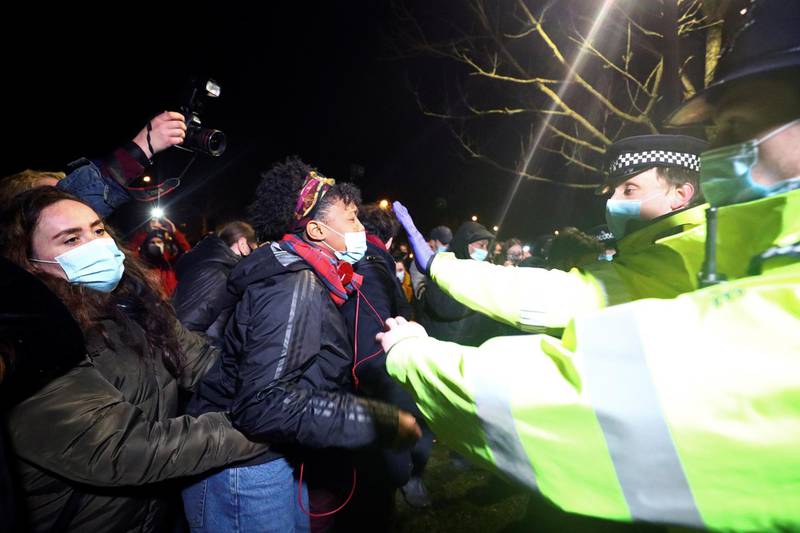 People clash with police during a gathering at a memorial site in Clapham Common bandstand, London. Reuters