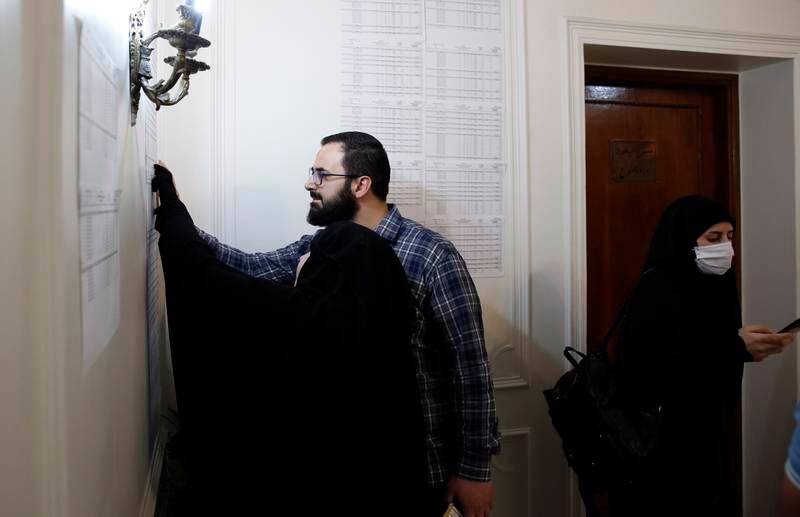 A Lebanese couple residing in Iran checks candidates list during the parliamentary elections at a polling station at the Lebanon embassy in Tehran, Iran. EPA