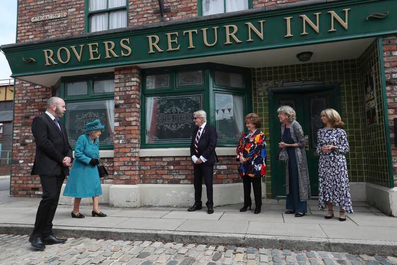 Queen Elizabeth meets the show's stars on a visit to the set of the long-running television soap opera Coronation Street, in 2021. Getty Images