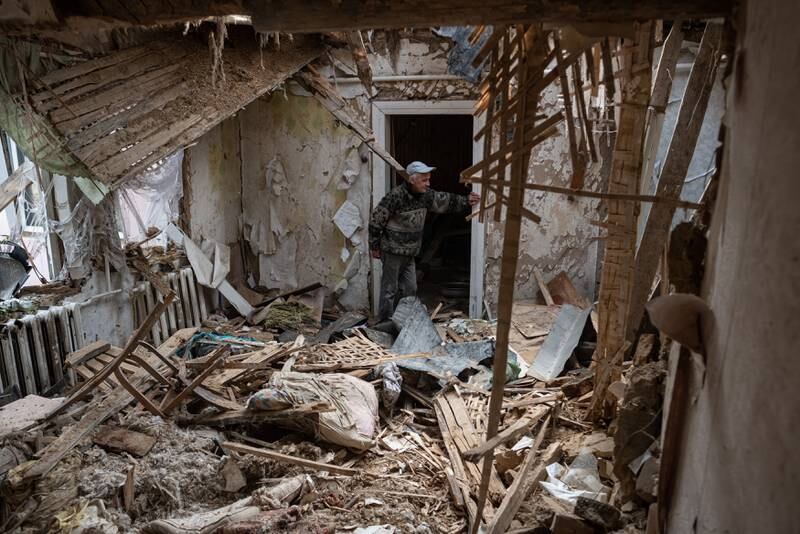 Yurii, 53, stands in his heavily damaged house in Fenevychi. Getty Images