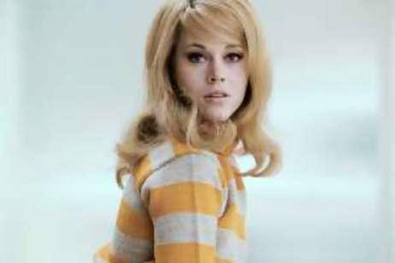 A young Jane Fonda in a waist length shot poses in a mustard yellow sweater. --- Image by © Bettmann/CORBIS