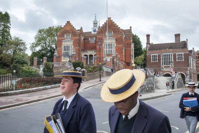 HARROW, UNITED KINGDOM - SEPTEMBER 16, 2015: Pupils make their way to class at Harrow School. Harrow School is an English independent school for boys situated in the town of Harrow, in north-west London. There is evidence that there has been a school on the site since 1243, but the Harrow School of today was formally founded in 1572 by John Lyon under a Royal Charter of Elizabeth I. Harrow is one of the original ten public schools that were regulated by the Public Schools Act 1868. The School has an enrollment of around 814 boys spread across twelve boarding houses, all of whom board full-time. It remains one of the four all-boys, full-boarding schools in Britain, the others being Eton College, Radley College and Winchester College. Harrow's uniform includes straw hats, morning suits, top hats and canes. Its long line of famous alumni includes eight former British/Indian Prime Ministers including Churchill, Baldwin, Peel, and Palmerston. (Photo by Peter Dench/Getty Images Reportage)