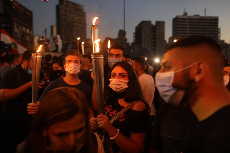 People hold Lebanese flags and lit candles to mark the one-year anniversary of anti-government protests in Beirut, Lebanon. Getty Images