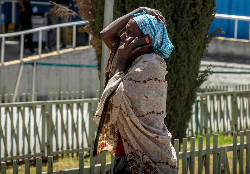 A family member of a victim involved in a plane crash talks on a mobile phone at Addis Ababa international airport Sunday, March 10, 2019. An Ethiopian Airlines flight crashed shortly after takeoff from Ethiopia's capital on Sunday morning, killing all 157 people thought to be on board, the airline and state broadcaster said, as anxious families rushed to airports in Addis Ababa and the destination, Nairobi. (AP Photo/Mulugeta Ayene)