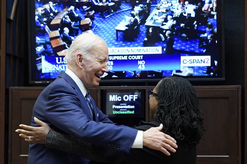 President Joe Biden goes to hug Supreme Court nominee Judge Ketanji Brown Jackson. AP