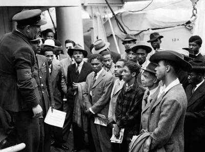 Jamaican immigrants welcomed by RAF officials in 1948 after the ex-troopship HMT Empire Windrush landed them at Tilbury. Photo: PA Images