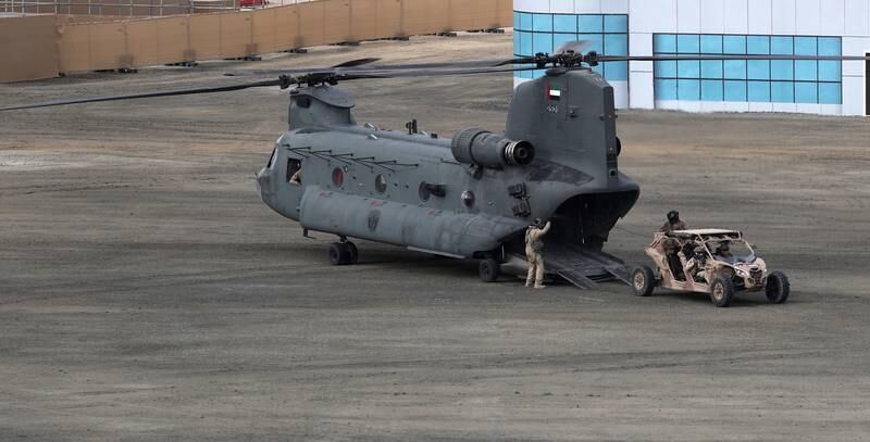 A Chinook helicopter drops off military buggies on the parade ground. EPA