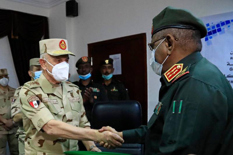 Egyptian military Chief of Staff Mohamed Farid shakes hands with his Sudanese counterpart Mohamed Othman al-Hussein after signing a bilateral agreement during a meeting of the Egyptian-Sudanese military committee, in Sudan's capital Khartoum. AFP