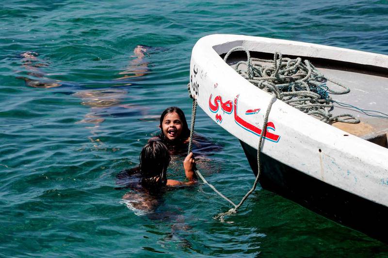 Girls swim in waters off the Lebanese capital Beirut. AFP