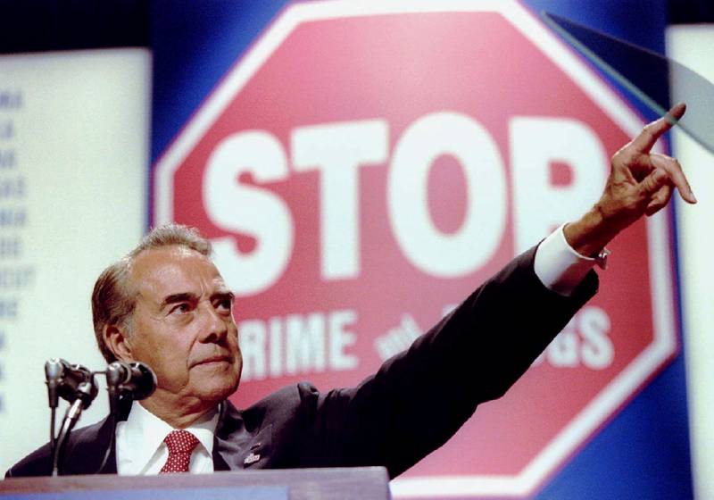 Republican presidential candidate Bob Dole points to a victim of crime in the audience while spelling out his plans to battle drugs and violent crime, at Villanova University, in September 1996. Reuters