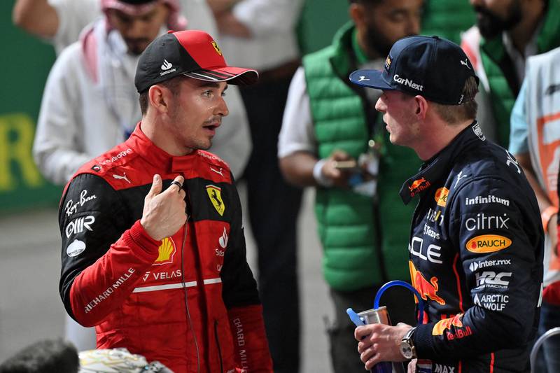 Ferrari's driver Charles Leclerc chats with Red Bull's Dutch driver Max Verstappen after the race. AFP