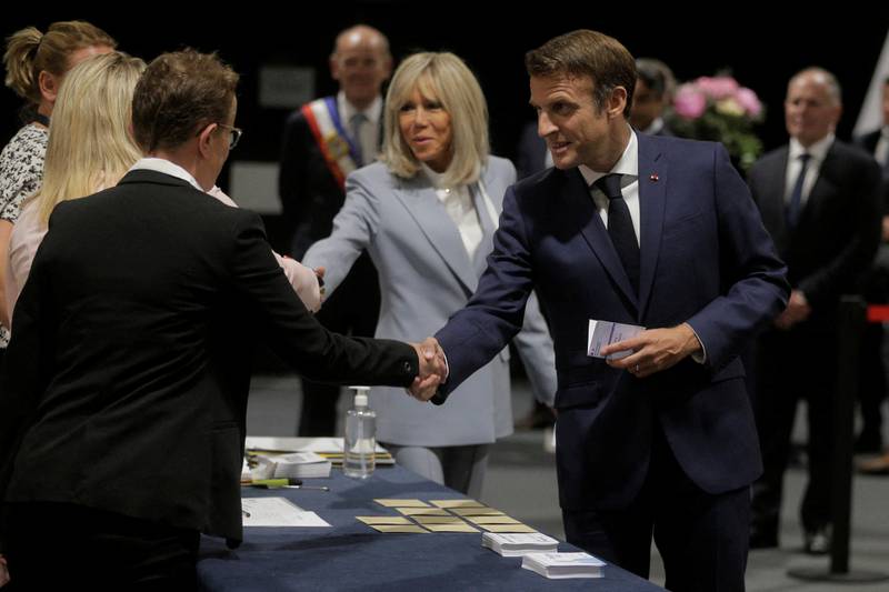 The French president and his wife Brigitte Macron arrive to vote. Reuters