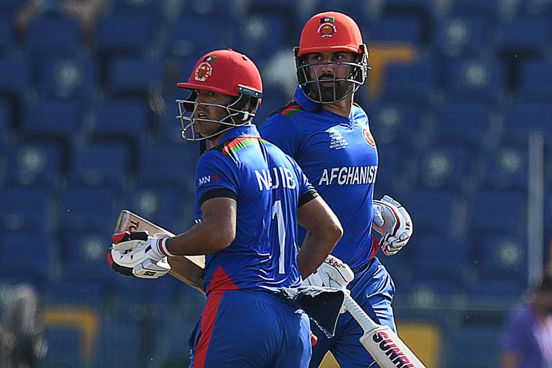 Afghanistan's Najibullah Zadran, left, and captain Mohammad Nabi run between the wickets at the Zayed Cricket Stadium. AFP