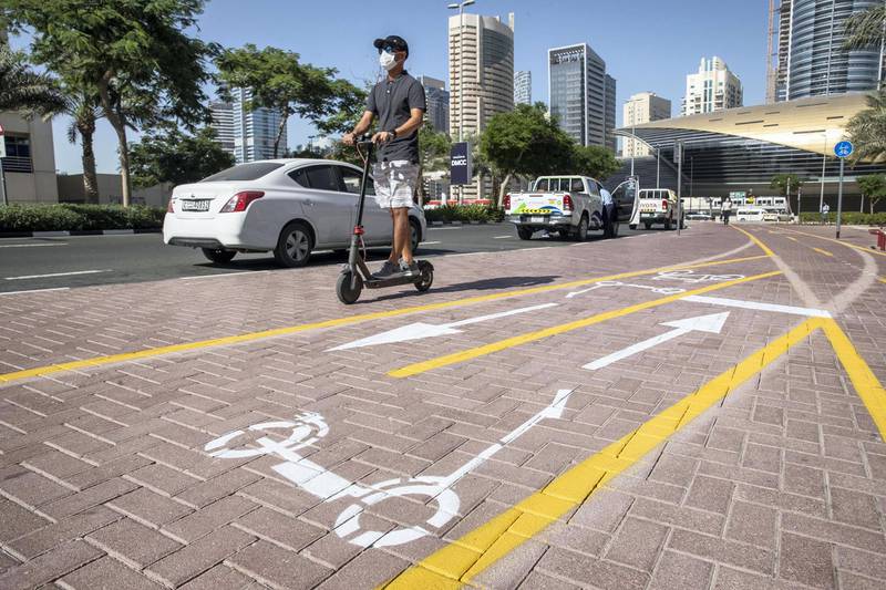 DUBAI, UNITED ARAB EMIRATES. 26 OCTOBER 2020. E-scooter trials rolled out in five areas across city for a year long project for commuters to rent and use e-scooters while commuting to and from tram and metro stations. Special cycle and scooter lanes in JLT next to Al Mas tower. (Photo: Antonie Robertson/The National) Journalist: Kelly Clarke. Section: National.