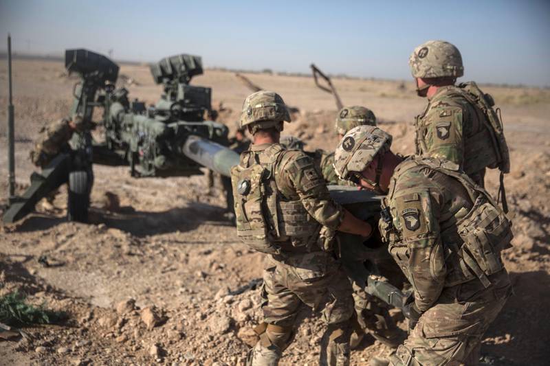 FILE - In this June 10, 2017 photo provided by Operation Resolute Support, U.S. Soldiers with Task Force Iron maneuver an M-777 howitzer, so it can be towed into position at Bost Airfield, Afghanistan.  Reversing his past calls for a speedy exit, U.S. President Donald Trump recommitted the United States to the 16-year-old war in Afghanistan Monday night, Aug. 21, 2017,  declaring U.S. troops must "fight to win." He pointedly declined to disclose how many more troops will be dispatched to wage America's longest war.(U.S. Marine Corps photo by Sgt. Justin T. Updegraff, Operation Resolute Support via AP, File)