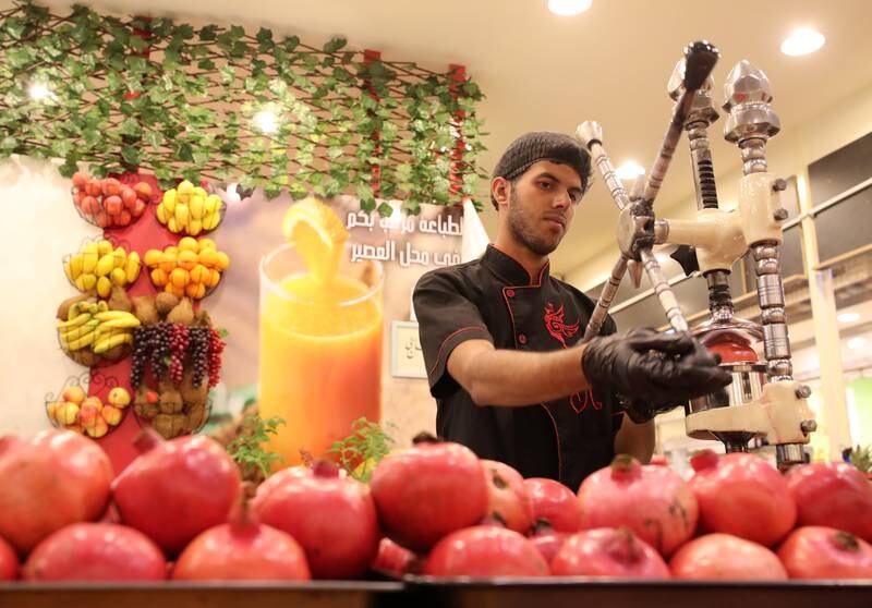 Fresh pomegranate juice is made in the Iran pavilion