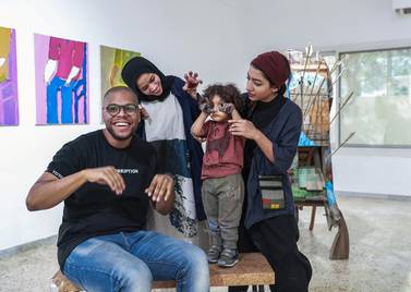 Bait 15 artists Hashel Al Lamki, Afra Al Dhaheri and Maitha Abdalla, who poses with her son, Mubarak. Victor Besa / The National 