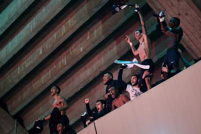 PSG players celebrate on the top tier of the stadium as fans gather below. AFP