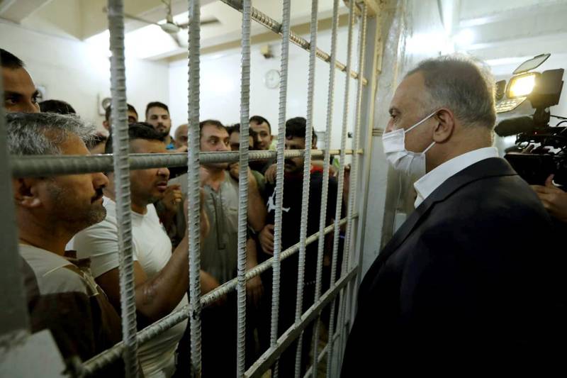 Iraqi Prime Minister Mustafa al-Kadhimi talks to prisoners during his visit in the central investigation prison in Al-Muthana airport in Baghdad, Iraq July 30, 2020. Iraqi Prime Minister Media Office/Handout via REUTERS ATTENTION EDITORS - THIS IMAGE WAS PROVIDED BY A THIRD PARTY.