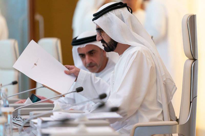 Sheikh Mohammed bin Rashid, Prime Minister and Ruler of Dubai, looks over the new national wellbeing strategy with Sheikh Saif bin Zayed, Deputy Prime Minister and Minister of Interior. Courtesy Dubai Media Office
