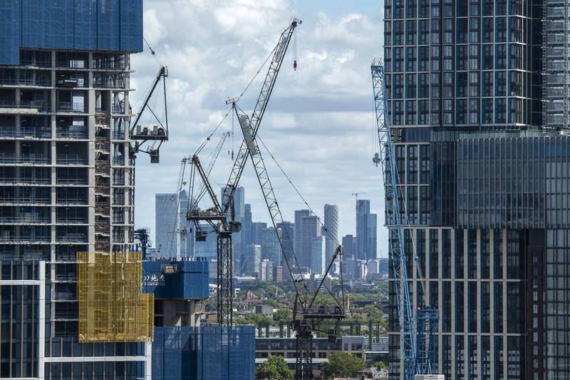 Canary Wharf financial district is seen in the distance as construction work continues on the One Nine Elms development site in south west London on August 2, 2020. - Plans for a shake-up of a "complex and outdated planning system" are due to be announced in the week, in a bid to speed up the building of new homes. (Photo by JUSTIN TALLIS / AFP)