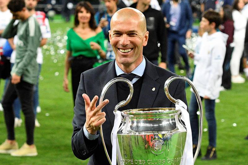 (FILES) In this file photo taken on May 26, 2018 Real Madrid's French coach Zinedine Zidane poses with the trophy after winning  the UEFA Champions League final football match between Liverpool and Real Madrid at the Olympic Stadium in Kiev, Ukraine.  / AFP / GENYA SAVILOV
