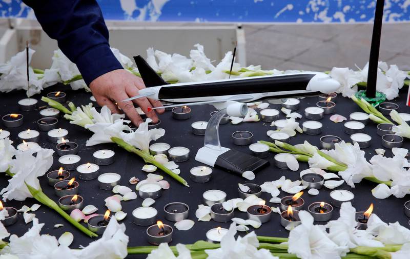 Students light candles during a memorial ceremony for passengers of Ukraine airplane at the Tehran university. EPA