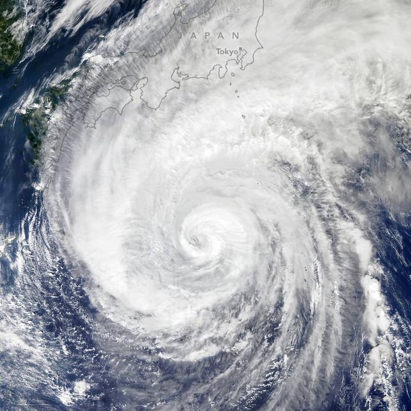 A handout photo made available by NASA Earth Observatory of a satellite image showing Typhoon Hagibis spinning toward the north-northwest over the western Pacific Ocean as its outer cloud bands near Japan.  EPA
