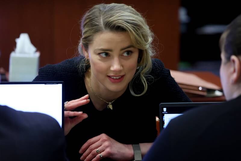 Actress Amber Heard speaks to her legal team. EPA