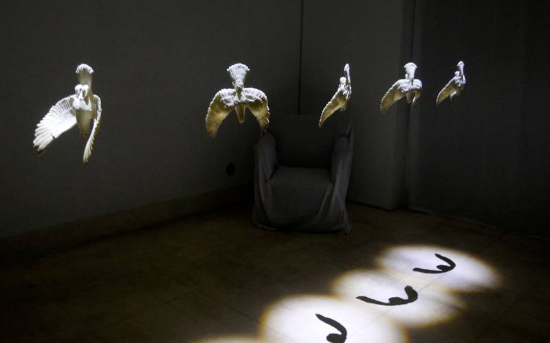 An art installation using fake pigeons is pictured in an art gallery in old Damascus, as part of an exhibition titled 'Once Upon a Time. . .  Windows', in the Syrian capital, on April 8, 2022.  - The collective exhibition by young Syrian artists, curated by Samer Kuzah, is shown at the Samer Kuzah art gallery and the streets around it, and represents through the installations using fake pigeons and other objects, aspects of life in Syria, such as war, the high cost of living and immigration.  (Photo by LOUAI BESHARA  /  AFP)