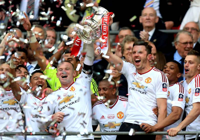 Manchester United's Wayne Rooney (left) lifts the FA Cup trophy after the Emirates FA Cup Final at Wembley Stadium on May 21, 2016. PA