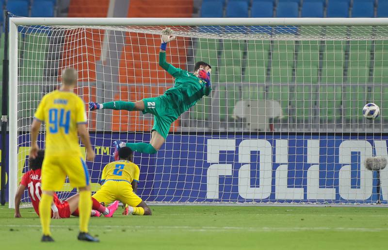 Al Gharafa goalkeeper Yousef Hassan watches the ball fly into the goal. AFP
