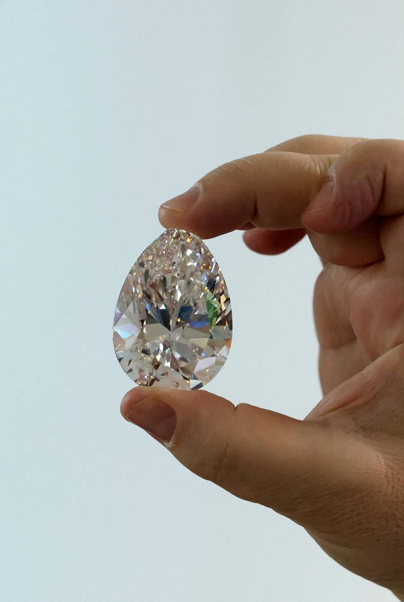 A Christie's auction house member of staff displays the giant diamond, nicknamed The Rock, in Dubai on March 25. All photos: AFP