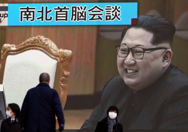 People walk past a public TV screen showing North Korean leader Kim Jong Un, in Tokyo Wednesday, March 7, 2018. After years of refusal, North Korean leader Kim Jong Un is willing to discuss the fate of his atomic arsenal with the United States and has expressed a readiness to suspend nuclear and missile tests during such talks, a senior South Korean official said Tuesday. (AP Photo/Eugene Hoshiko)