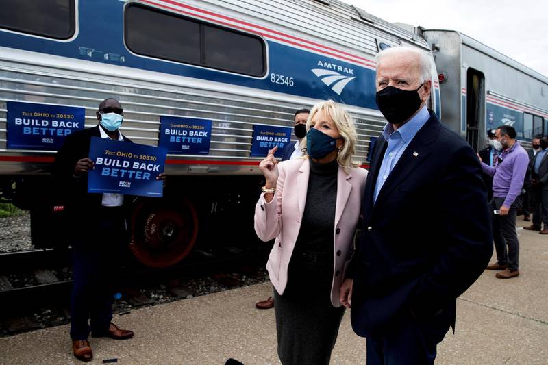 FILE PHOTO: U.S. Democratic presidential candidate and former Vice President Joe Biden and his wife Jill greet supporters as they prepare to board an Amtrak train to begin a campaign train tour in Cleveland, Ohio, U.S., September 30, 2020. REUTERS/Mike Segar/File Photo