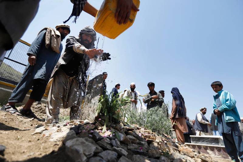 epa07564136 A man pours water on the grave of Afghan female journalist and political advisor Mena Mangal, a day after she was killed by unknown gunmen in downtown Kabul, Afghanistan, 12 May 2019. The 27-year-old prominent Afghan journalist and political adviser was shot dead in Kabul on 11 May, few days after she posted on social media that she is receiving threatening messages.  EPA/JAWAD JALALI