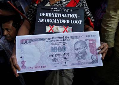 A demonstrator holds a replica of an abolished 1000 ruppee note during a protest, organised by India's main opposition Congress party, to mark a year since demonetisation was implemented by Prime Minister Narendra Modi, in Kolkata, India, November 8, 2017. REUTERS/Rupak De Chowdhuri