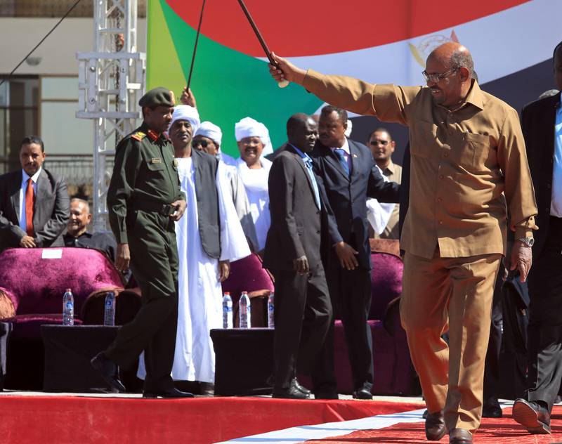 FILE - In this Wednesday, Jan. 9, 2019 file photo, Sudanese President Omar al-Bashir greets his supporters at a rally in Khartoum, Sudan. The anti-government protests rocking Sudan for the past month are reminiscent of the Arab Spring uprisings of nearly a decade ago. Demonstrators, many in their 20s and 30s, are trying to remove President Omar al-Bashir, an authoritarian leader, and win freedoms and human rights. (AP Photo/Mahmoud Hjaj, file)