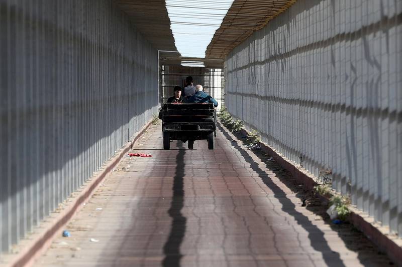 A Christian Palestinian couple riding an auto rickshaw leaves Gaza Strip through Israeli Erez crossing heading to Bethlehem to attend Christmas celebrations, in the northern Gaza Strip December 24, 2019. REUTERS/Mohammed Salem     TPX IMAGES OF THE DAY