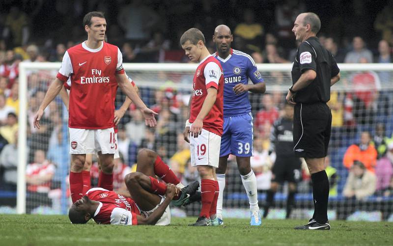 Abou Diaby of Arsenal clutches his right ankle as he lies injured (Photo by Catherine Ivill/AMA/Corbis via Getty Images)