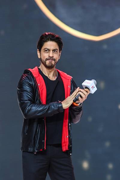 Bollywood actor Shah Rukh Khan gestures as he speaks during the unveiling of the company's 100 millionth motorcycle, in Gurgaon on January 21, 2021. / AFP / Money SHARMA
