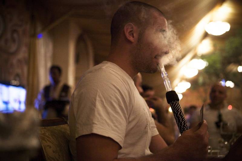 Smoking shisha with family and friends is a way of life that doesn't need to hurt children. Lee Hoagland / The National
