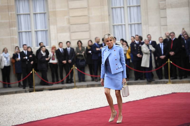 Brigitte, wearing a baby blue Louis Vuitton suit, arrives at the Elysee presidential palace on May 14, 2017, in Paris. AFP